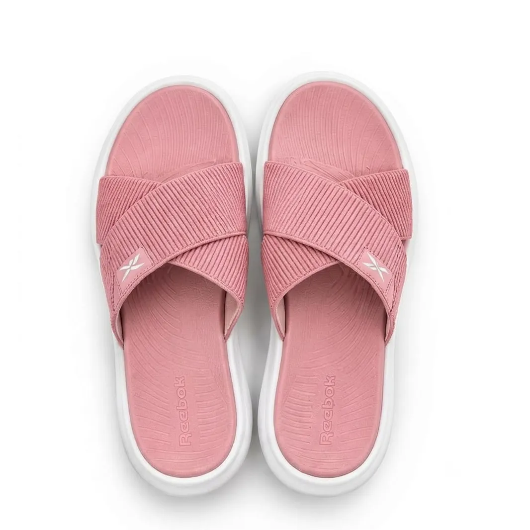 Reebok Reflux Stack women's sandals in Coral Rose pink with ribbed crossover straps and white sole.
